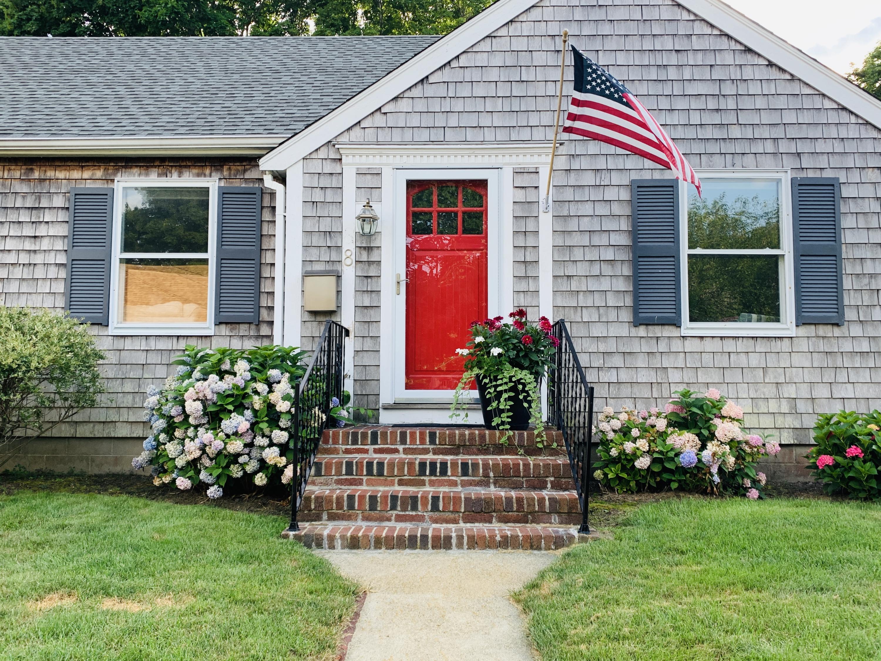 a front view of a house with garden