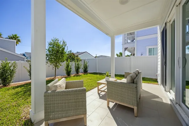 a kitchen with a refrigerator a stove a sink and a dining table with wooden floor