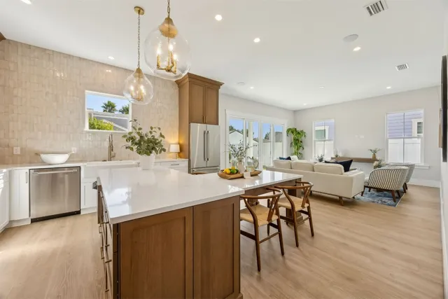 a view of a hallway with wooden floor and entryway