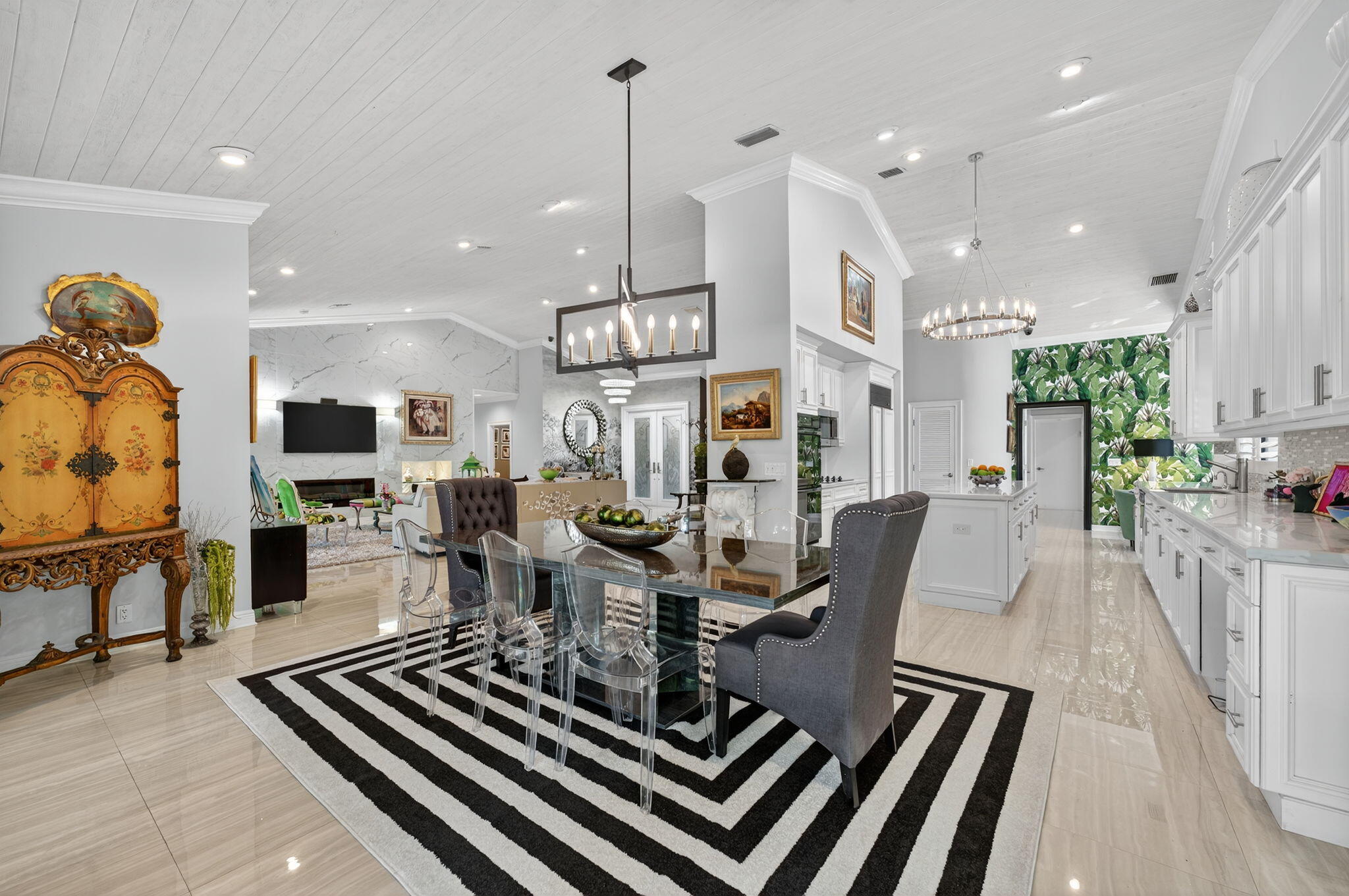 7205 Mandarin Drive Boca Raton, FL 33433 - Photo 15 of 71 a view of a dining room and livingroom with furniture wooden floor a rug a fireplace and a chandelier