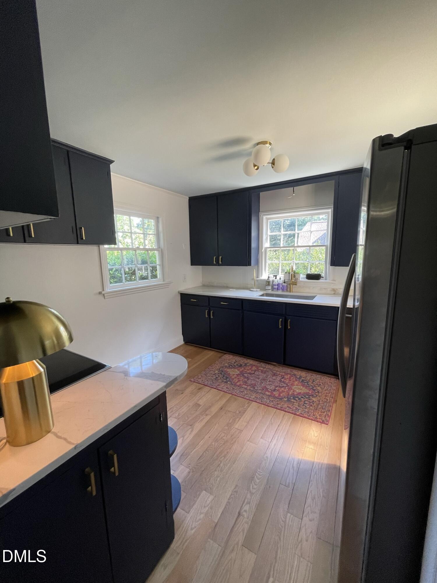 1009 Canterbury Road Raleigh, NC 27607 - Photo 24 of 31 a kitchen with granite countertop a refrigerator and a sink