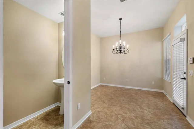 a view of a hallway with entryway and wooden floor