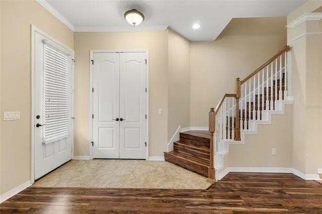 a view of a room with wooden floor and a window