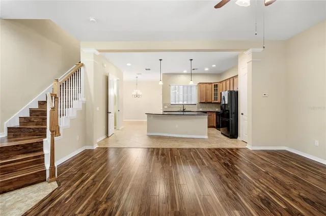 a view of a kitchen with wooden floor and electronic appliances