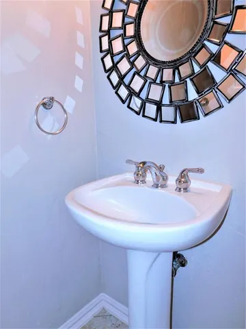a bathroom with a sink and mirror
