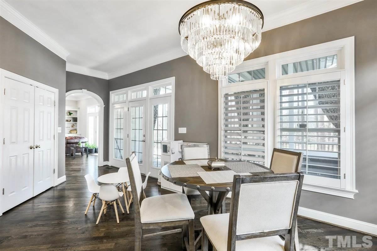 12317 Beestone Lane Raleigh, NC 27614 - Photo 11 of 30 a view of a dining room with furniture wooden floor and chandelier
