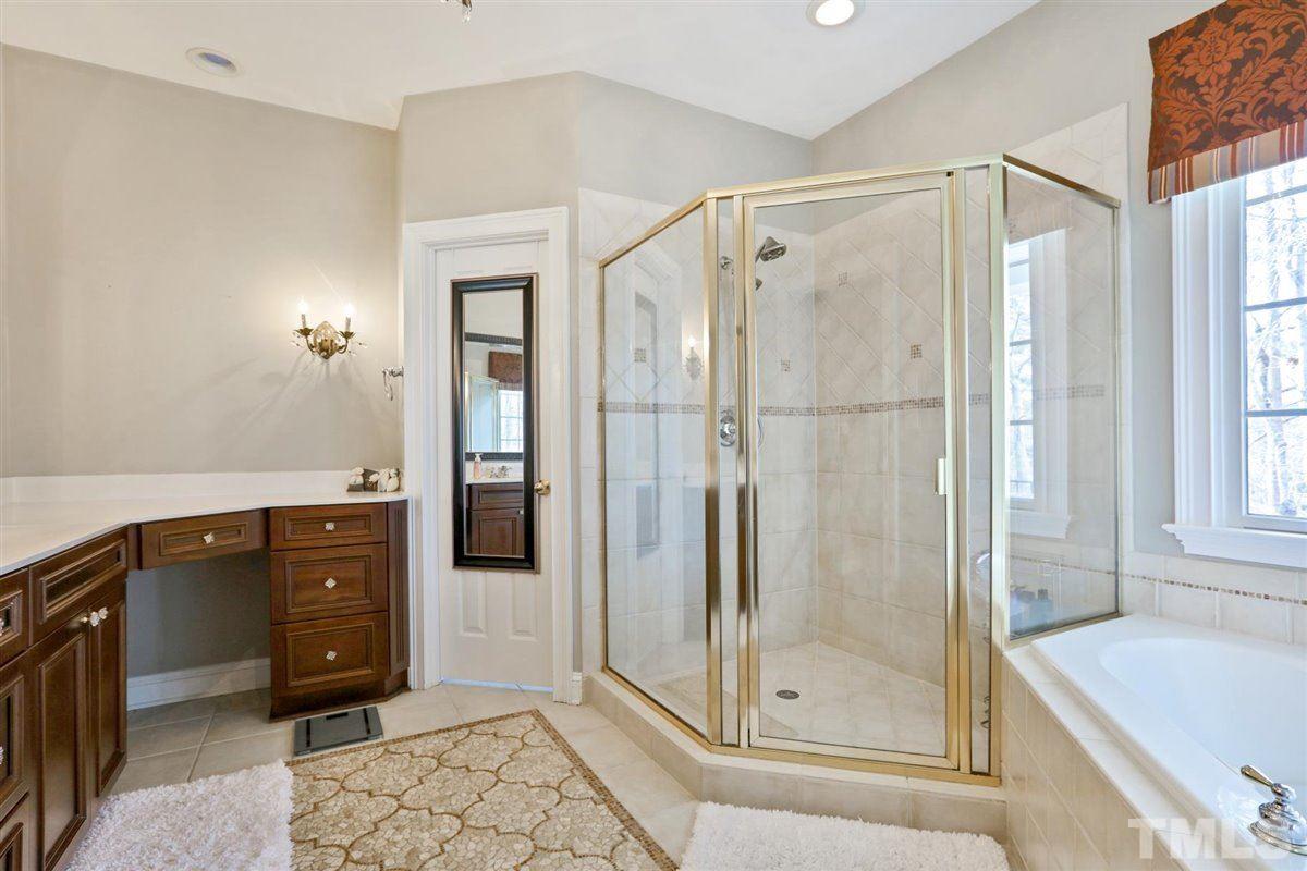 12317 Beestone Lane Raleigh, NC 27614 - Photo 12 of 30 a bathroom with a tub shower vanity and sink
