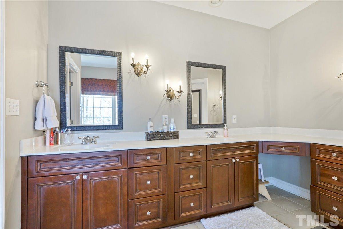 12317 Beestone Lane Raleigh, NC 27614 - Photo 15 of 30 a bathroom with a granite countertop double vanity sink and mirror