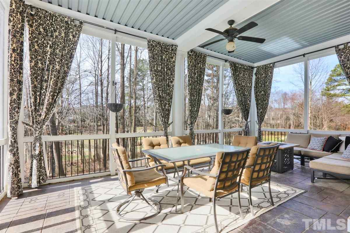 12317 Beestone Lane Raleigh, NC 27614 - Photo 18 of 30 a dining room with furniture a chandelier and wooden floor