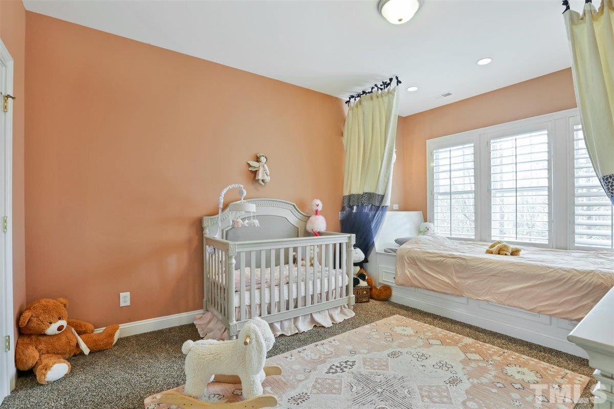12317 Beestone Lane Raleigh, NC 27614 - Photo 20 of 30 a bedroom with a bed and a window
