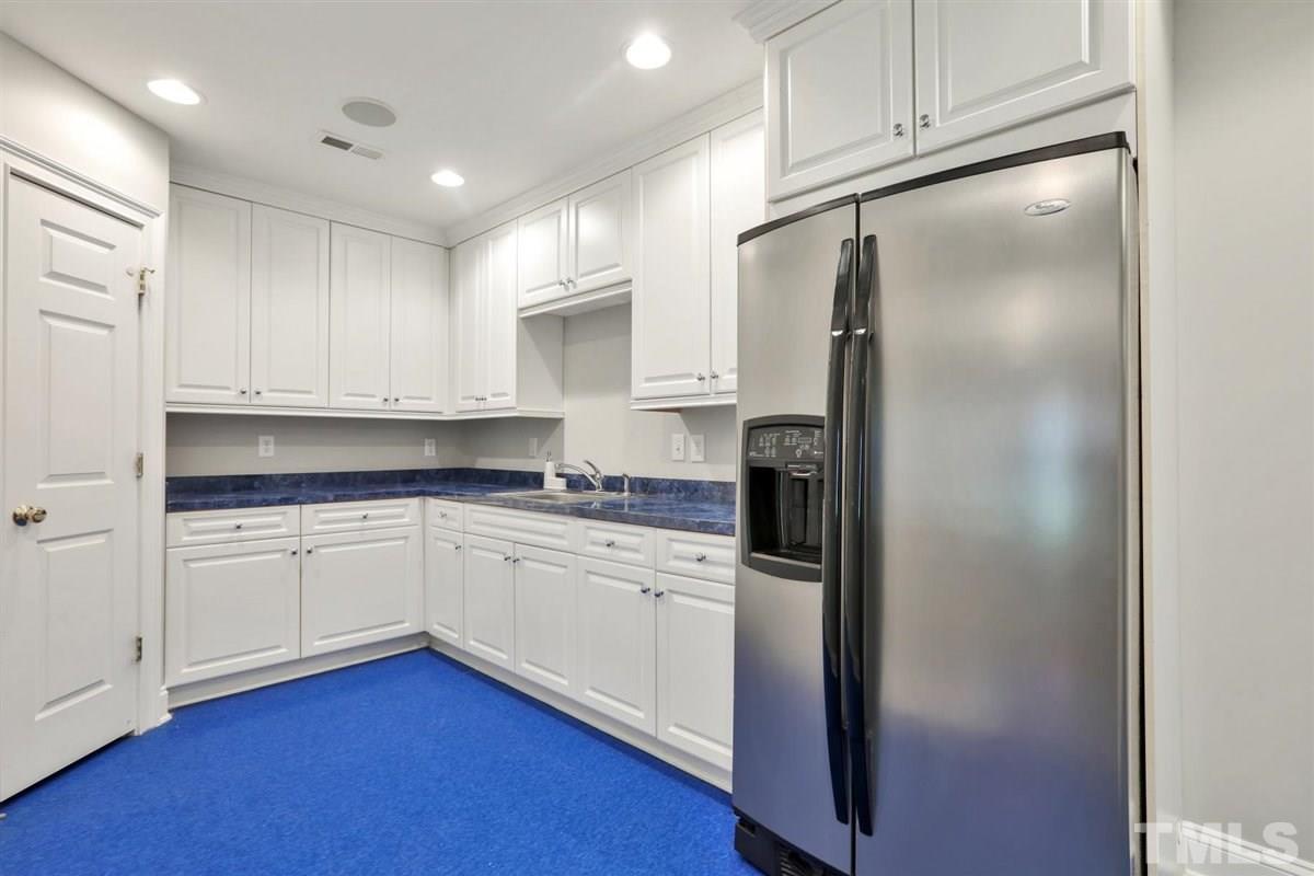 12317 Beestone Lane Raleigh, NC 27614 - Photo 22 of 30 a kitchen with stainless steel appliances a refrigerator sink and cabinets