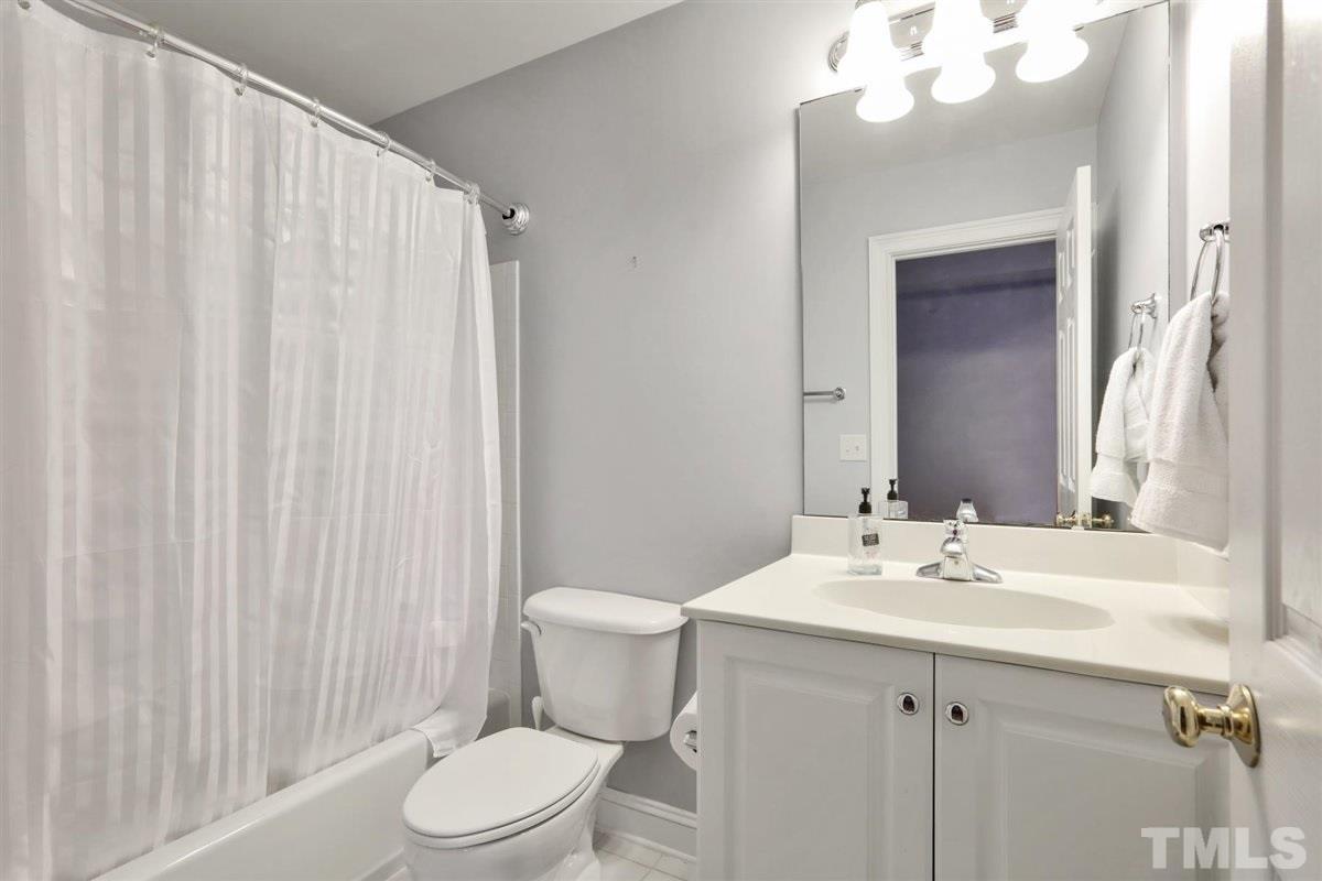 12317 Beestone Lane Raleigh, NC 27614 - Photo 24 of 30 a bathroom with a sink vanity mirror and toilet