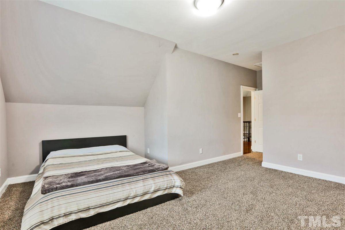 12317 Beestone Lane Raleigh, NC 27614 - Photo 26 of 30 a bedroom with a bed and pillows