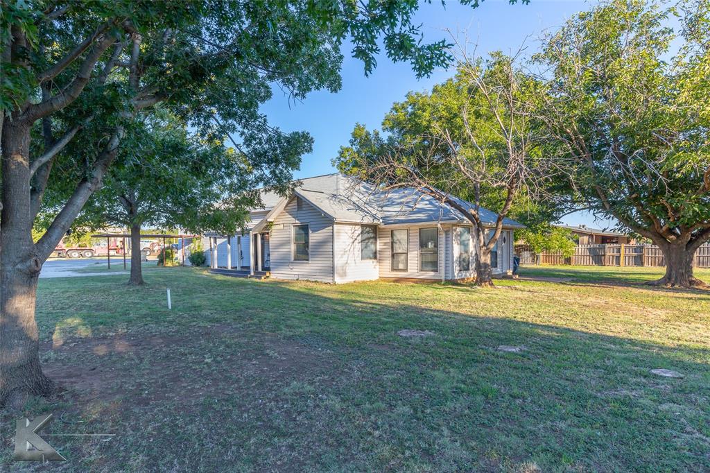 a front view of a house with a big yard