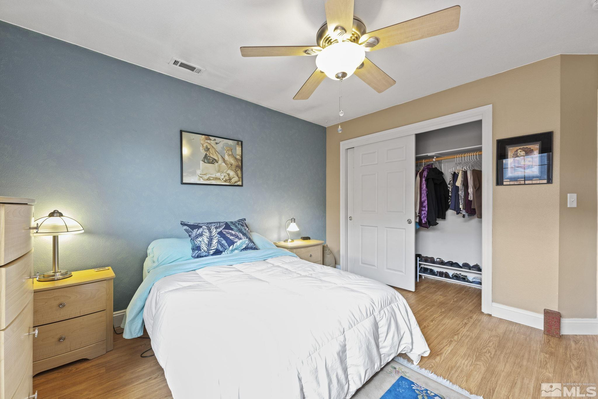 595 Roberts Street Reno, NV 89502 - Photo 15 of 24 a bedroom with a bed and a chandelier