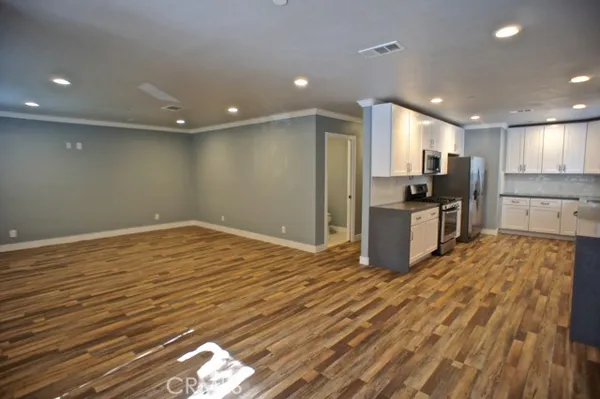 a kitchen with a sink a window and stainless steel appliances