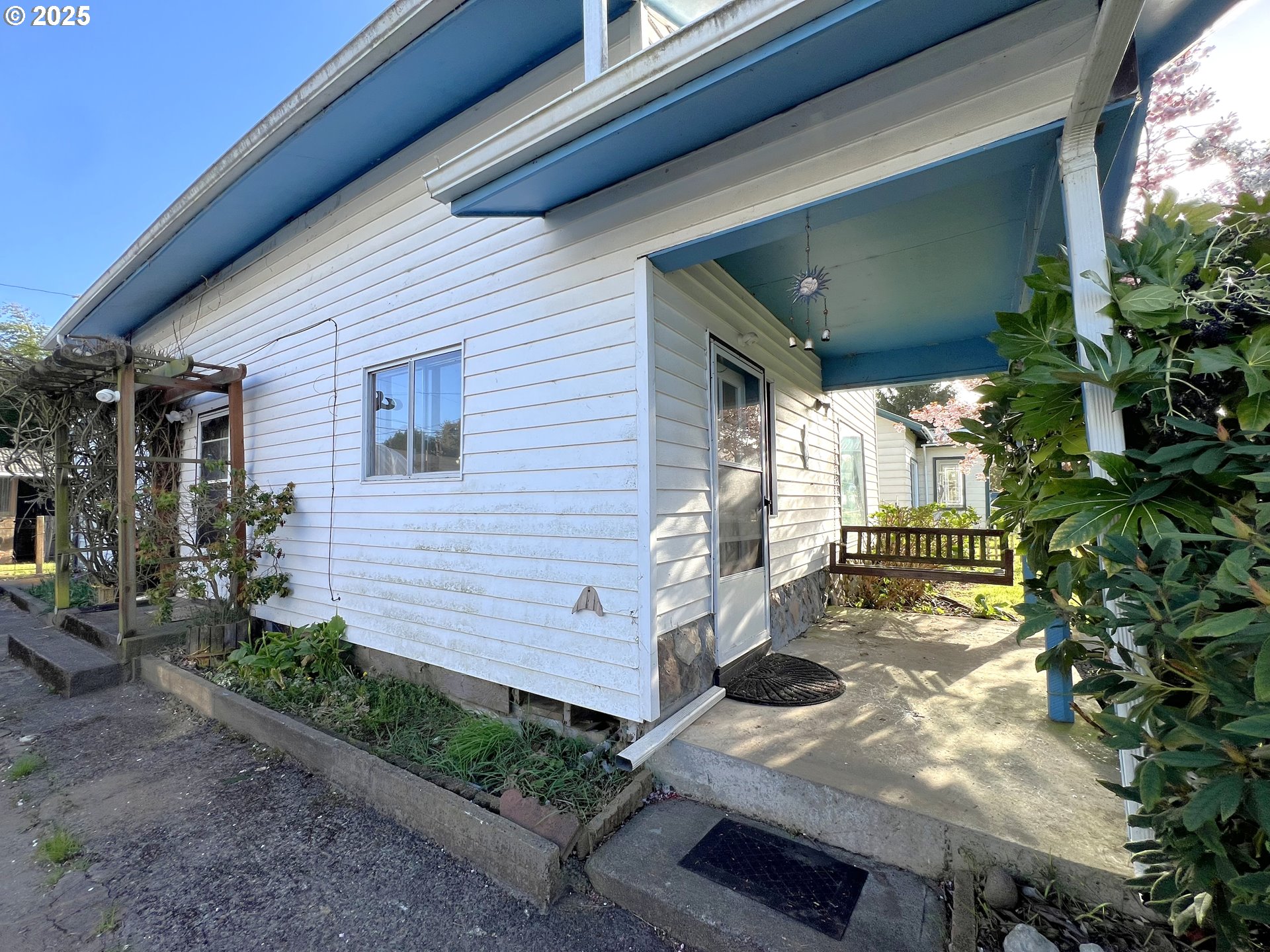 1042 Fir Avenue Reedsport, OR 97467 - Photo 34 of 47 a view of a porch with chairs and potted plants
