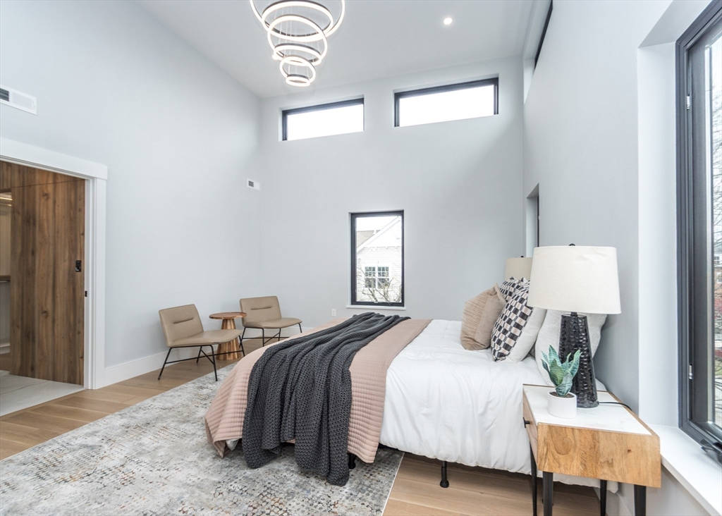 15 Alder Street, Unit 1 Waltham, MA 02453 - Photo 14 of 38 a bedroom with a bed and a lamp