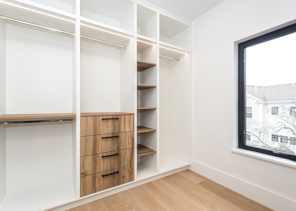 15 Alder Street, Unit 1 Waltham, MA 02453 - Photo 17 of 38 a view of walk in closet with empty racks