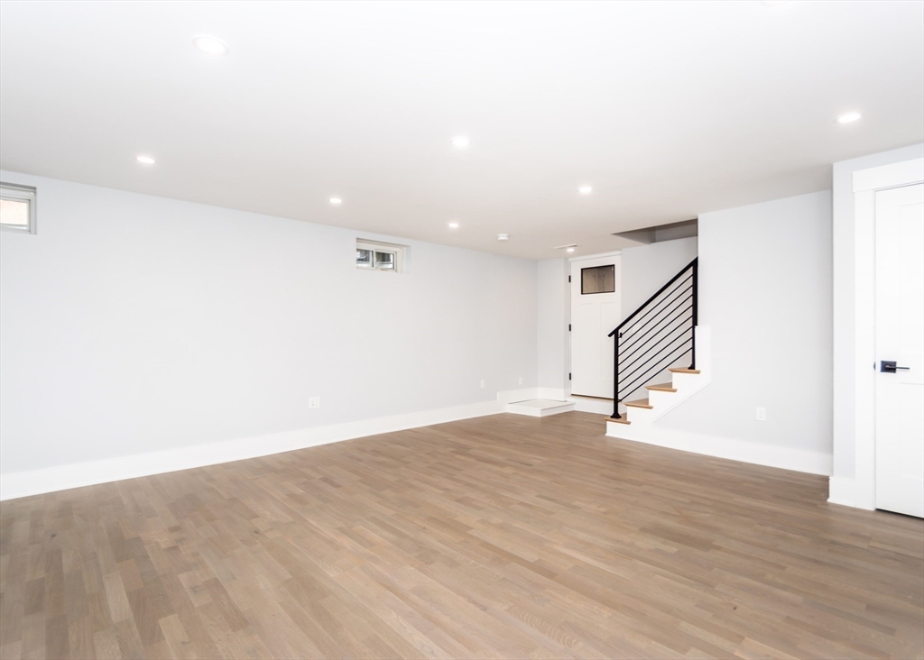 15 Alder Street, Unit 1 Waltham, MA 02453 - Photo 21 of 38 an empty room with wooden floor and white walls