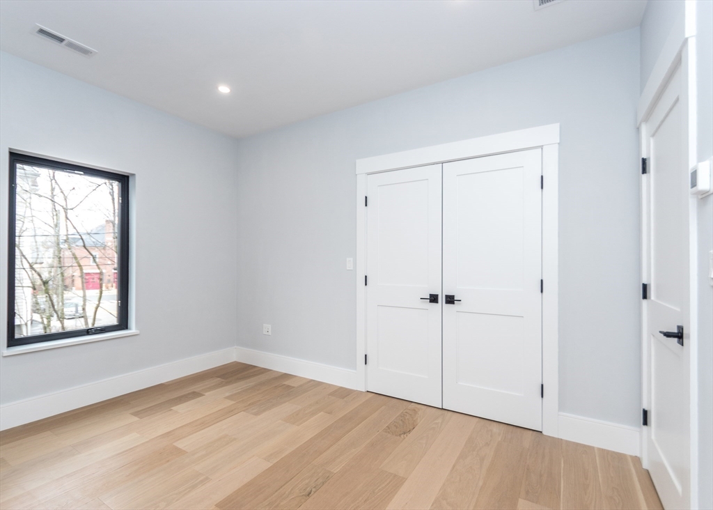 15 Alder Street, Unit 1 Waltham, MA 02453 - Photo 23 of 38 a view of an empty room with wooden floor