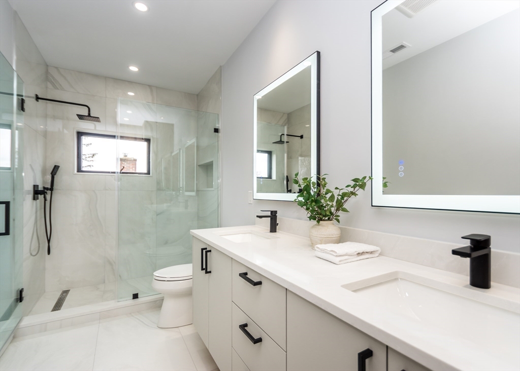15 Alder Street, Unit 1 Waltham, MA 02453 - Photo 28 of 38 a bathroom with a double vanity sink toilet and shower