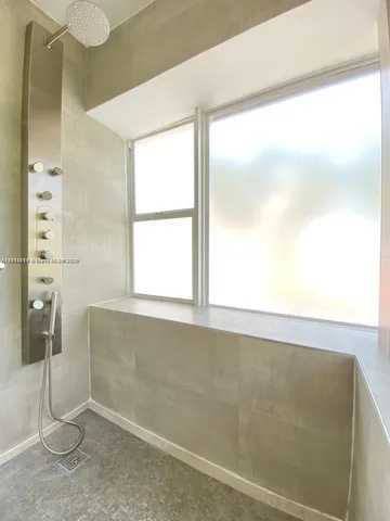 a view of a room with rack on the wall and a window