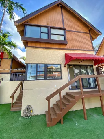 a view of backyard with deck and chair