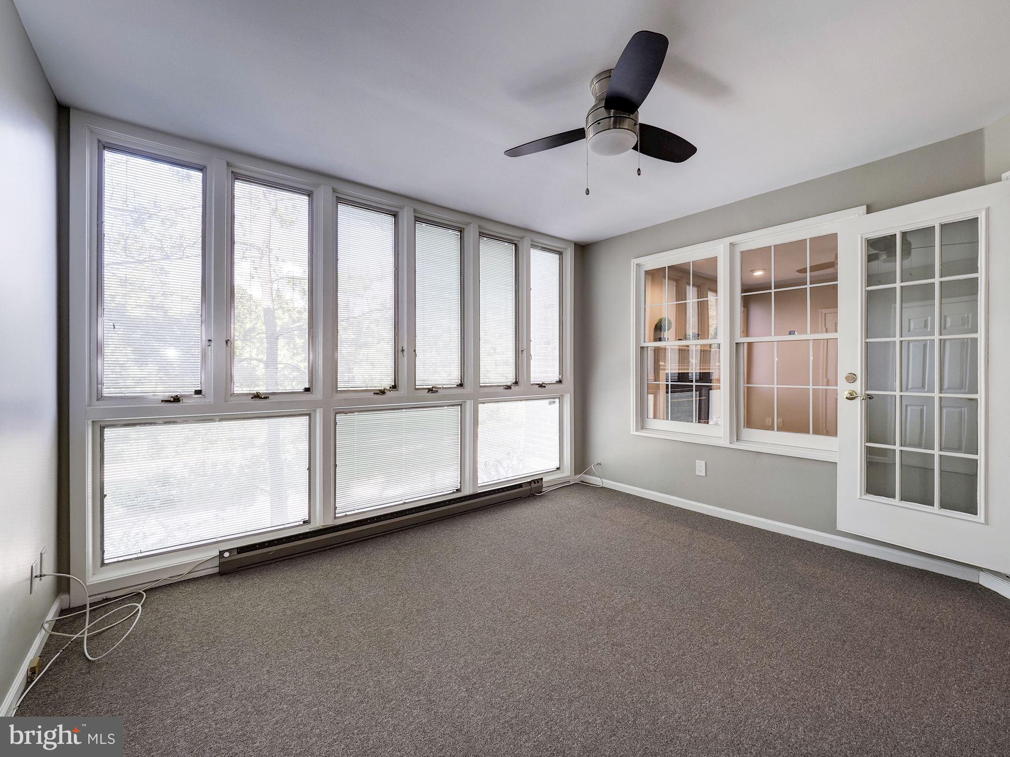 10708 Kings Riding Way, Unit 10119 Rockville, MD 20852 - Photo 16 of 37 Bright and sun-filled sunroom with ceiling fan