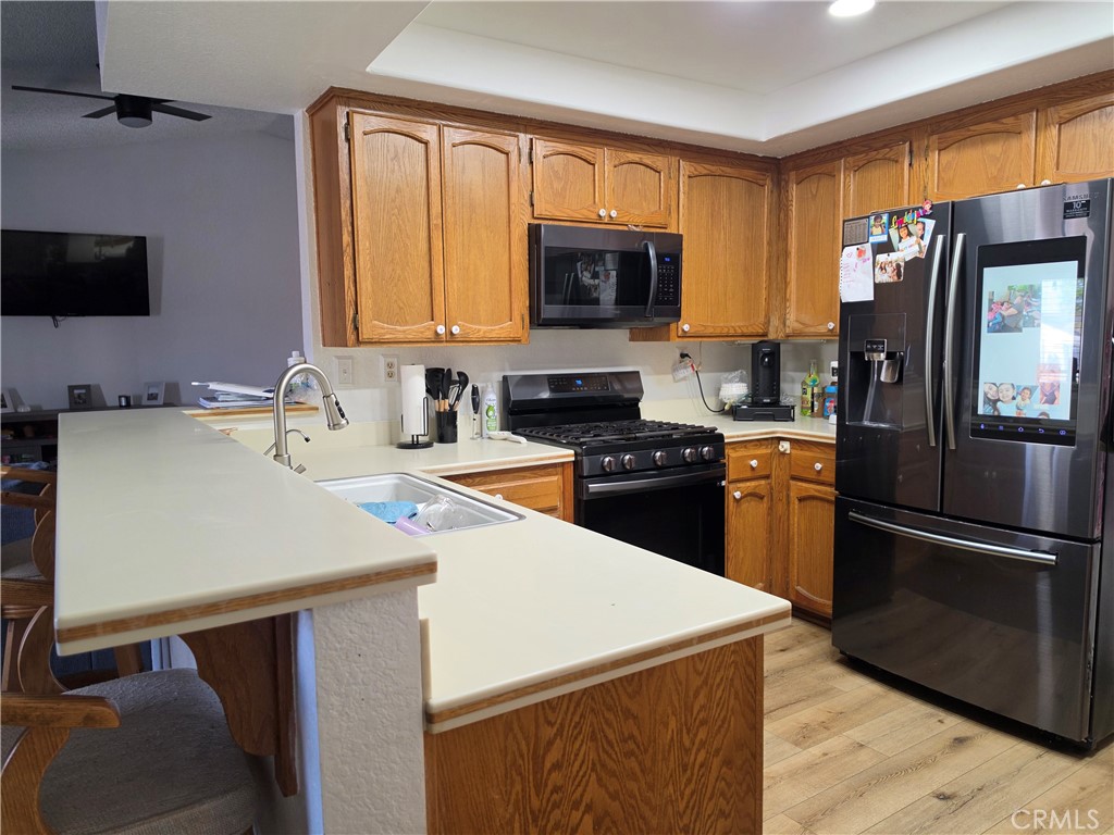 13502 Cuyamaca Road Apple Valley, CA 92308 - Photo 12 of 15 a kitchen with a sink a stove and a refrigerator