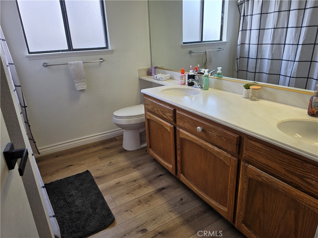 13502 Cuyamaca Road Apple Valley, CA 92308 - Photo 15 of 15 a bathroom with a sink and a toilet