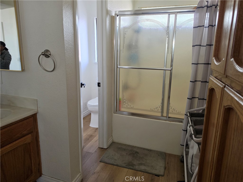 13502 Cuyamaca Road Apple Valley, CA 92308 - Photo 5 of 15 a bathroom with a glass shower door and a sink