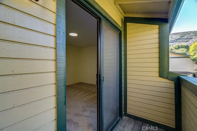 a front view of a house with a yard and large tree