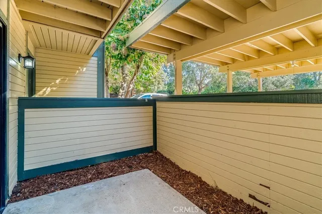 a view of a pathway of a house with wooden deck