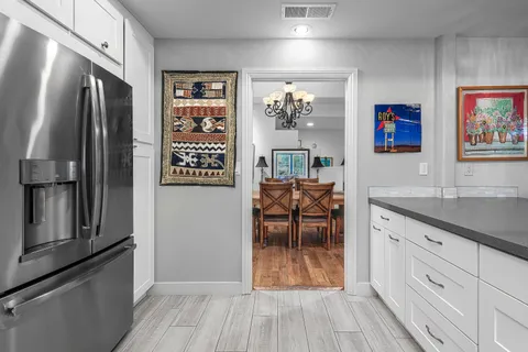 a kitchen with stainless steel appliances granite countertop a refrigerator and a stove top oven