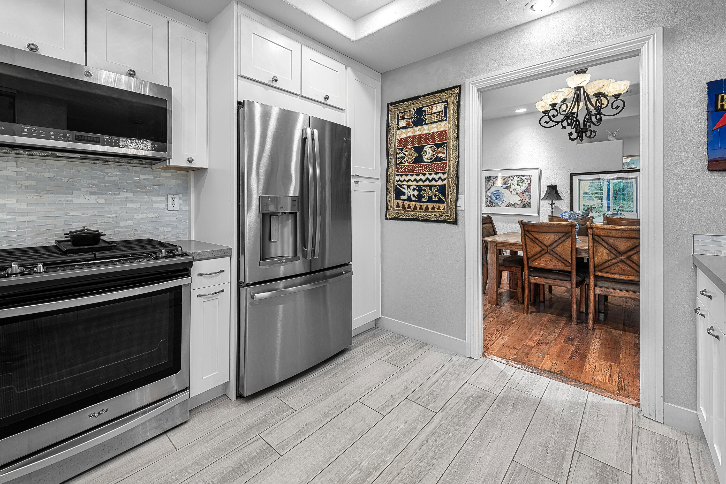 2264 Oakcrest Drive Palm Springs, CA 92264 - Photo 12 of 19 a kitchen with granite countertop a refrigerator stove and microwave with wooden floor