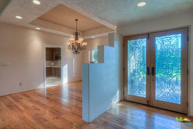 2264 Oakcrest Drive Palm Springs, CA 92264 - Photo 4 of 19 a view of a room with wooden floor fireplace and a window