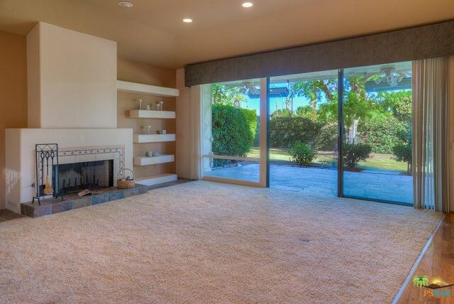 2264 Oakcrest Drive Palm Springs, CA 92264 - Photo 6 of 19 a view of an empty room with a fireplace and a floor to ceiling window