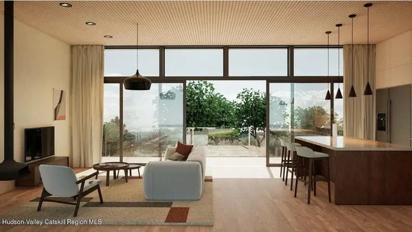 a living room with furniture a large window with kitchen view