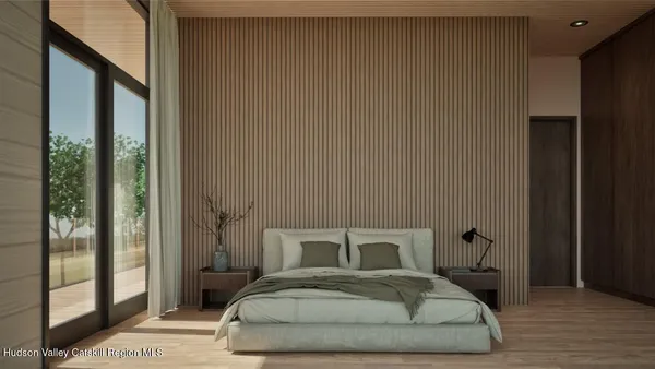 a bedroom with a bed and wooden floor