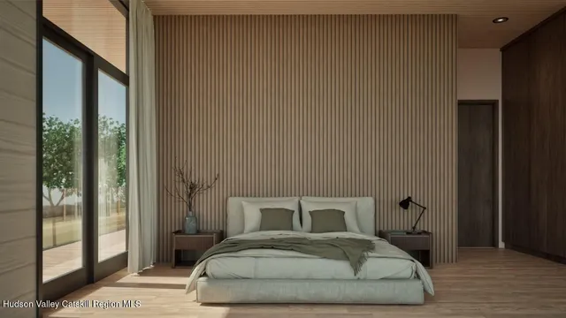 a bedroom with a bed and wooden floor