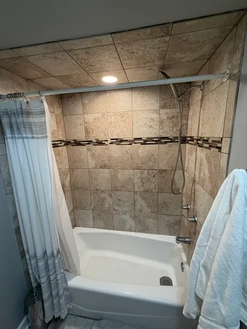 a bathroom with a bathtub and a shower