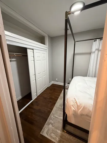 a bedroom with a bed and a mirror