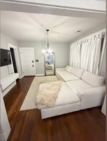 a spacious bedroom with a bed and a flat screen tv