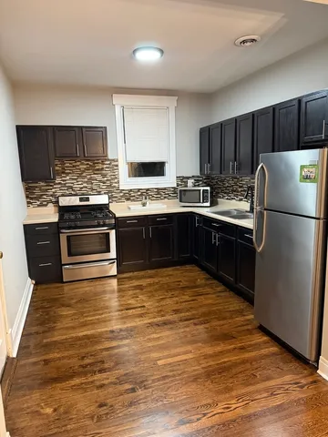a kitchen with stainless steel appliances granite countertop a stove and a refrigerator