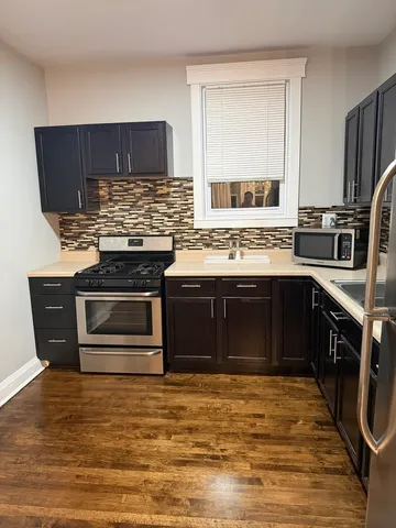 a kitchen with a stove and a refrigerator