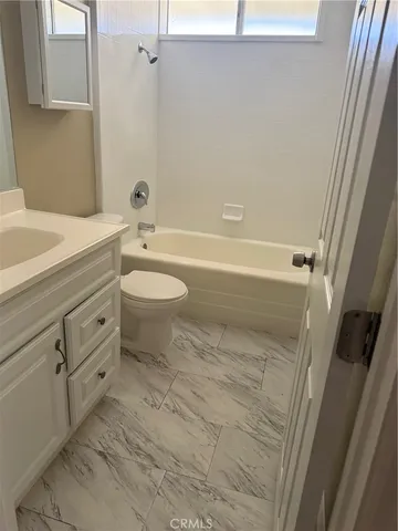 a bathroom with a toilet a sink and bathtub