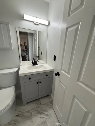 a bathroom with a sink toilet and mirror
