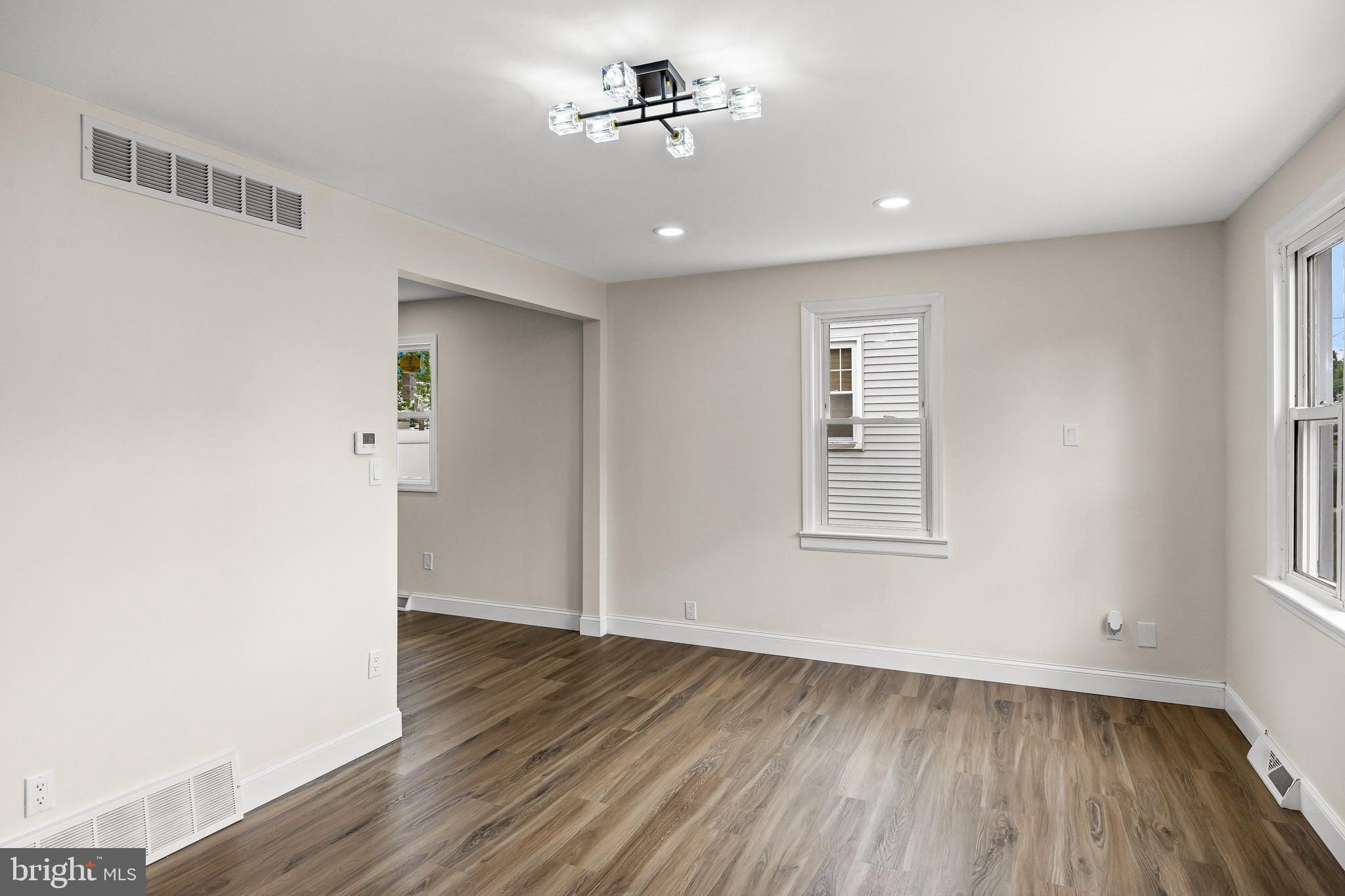 937 Clements Bridge Road Barrington, NJ 08007 - Photo 19 of 34 wooden floor in an empty room with a window