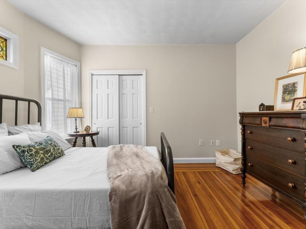 11 Doris Street, Unit 1 Boston, MA 02125 - Photo 11 of 17 a bedroom with a bed and wooden floor